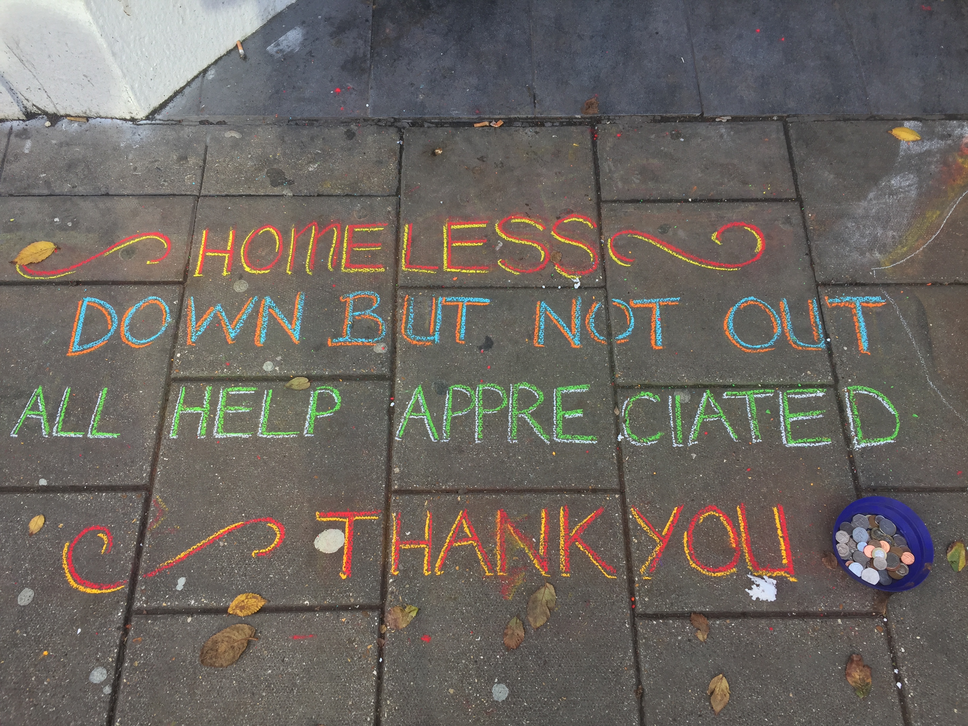 Homeless plea for help written on the ground