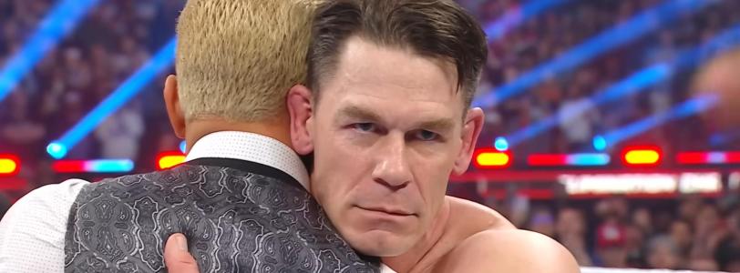 John Cena frowns at the camera while embracing Cody Rhodes at WWE Elimination Chamber